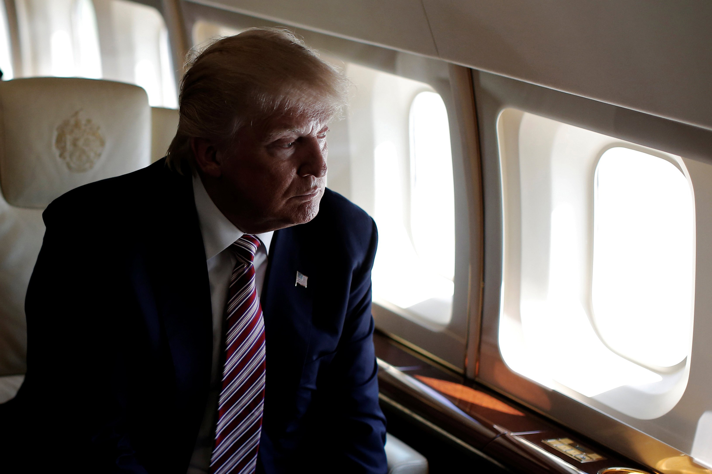 Image: Republican presidential nominee Donald Trump looks out the window as he travels aboard his plane between campaign stops in Ohio